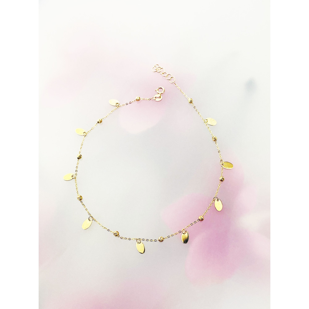 Złota bransoletka na nogę listki kulki